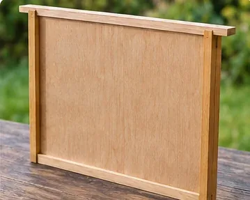 Solid wooden division board for separating hive compartments